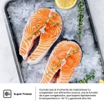 Dos filetes de salmón crudo sobre hielo con ramitas de tomillo y un gajo de limón